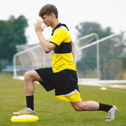 Teenage boy stretching before soccer game.